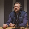 Jared Luttjeboer seated at a podcast microphone